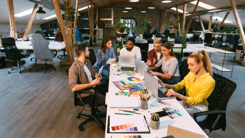 Creative team brainstorming brand strategy in modern office
